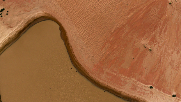 Aerial view of the salt lake at Useless Loop with brown water and surrounding red sand dunes in Kalbarri Western Australia Australia. Aerial view of the salt lake at Useless Loop with brown water and surrounding red sand dunes in Kalbarri Western Australia Australia.
