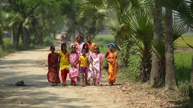 View of children in traditional dress on a rural road Bangladesh.