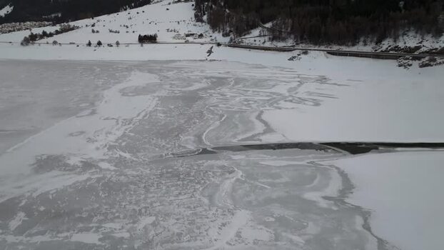 Aerial view of frozen Reschensee lake in winter Italy. Aerial view of frozen Reschensee lake in winter Italy.
