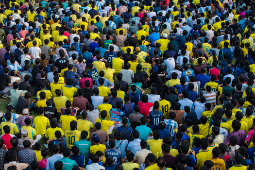 Dhaka Bangladesh 20 June 2026 Aerial view of Dhaka University Campus with a large crowd of football fans wearing yellow jerseys gathered on the grounds. Dhaka Bangladesh 20 June 2026 Aerial view of Dhaka University Campus with a large crowd of football fans wearing yellow jerseys gathered on the grounds.
