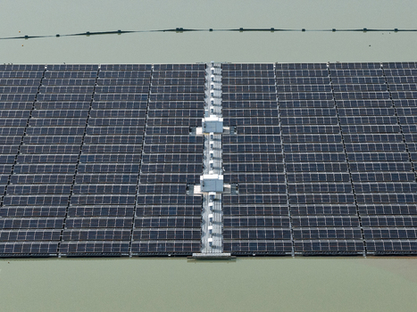 Aerial view of a floating solar farm on a calm lake with rows of photovoltaic panels and central maintenance platforms in Dulmen North Rhine Westphalia Germany. Aerial view of a floating solar farm on a calm lake with rows of photovoltaic panels and central maintenance platforms in Dulmen North Rhine Westphalia Germany.