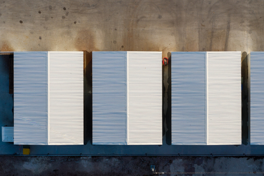 Aerial view of white storage containers arranged in rows on a concrete surface in Warsaw Masovian Voivodeship Poland.