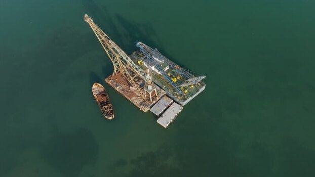 Aerial view of a floating crane barge and ship in Augusta Italy. Aerial view of a floating crane barge and ship in Augusta Italy.