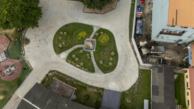 Aerial view of a small park with a central monument on Lagos Island surrounded by paved walkways green lawns and nearby urban buildings in Lagos Lagos Nigeria. Aerial view of a small park with a central monument on Lagos Island surrounded by paved walkways green lawns and nearby urban buildings in Lagos Lagos Nigeria.