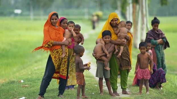 View of women and children in a rural field in Bangladesh. View of women and children in a rural field in Bangladesh.