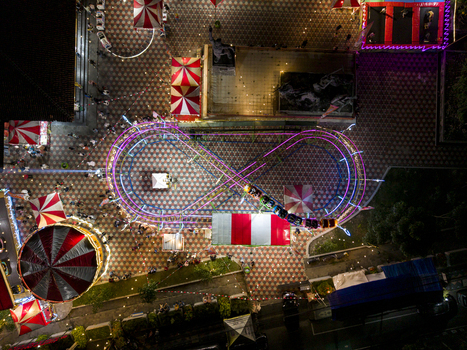 Aerial view of GOR Gelarsena Klaten Night Market with an infinity shaped roller coaster track striped tents and vibrant lights at night in Kecamatan Klaten Utara Jawa Tengah Indonesia. Aerial view of GOR Gelarsena Klaten Night Market with an infinity shaped roller coaster track striped tents and vibrant lights at night in Kecamatan Klaten Utara Jawa Tengah Indonesia.