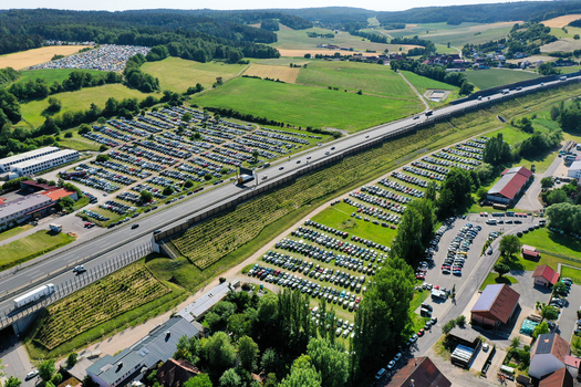 Aerial view of Eventzentrum Strohofer Geiselwind musichall with extensive parking lots and the motorway passing through green fields Geiselwind Bayern Germany. Aerial view of Eventzentrum Strohofer Geiselwind musichall with extensive parking lots and the motorway passing through green fields Geiselwind Bayern Germany.
