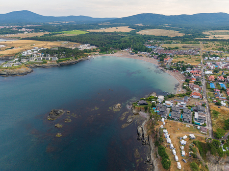 Aerial view of Arapya beach with its sandy coastline rocky cliffs surrounding holiday villas and lush greenery along the Black Sea coast in Burgas Bulgaria. Aerial view of Arapya beach with its sandy coastline rocky cliffs surrounding holiday villas and lush greenery along the Black Sea coast in Burgas Bulgaria.