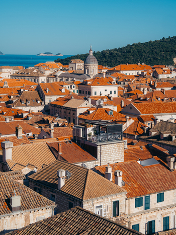 View of Dubrovnik Old Town featuring iconic orange tiled rooftops and the dome of the Cathedral under a clear blue sky Dubrovnik Dubrovnik Neretva County Croatia. View of Dubrovnik Old Town featuring iconic orange tiled rooftops and the dome of the Cathedral under a clear blue sky Dubrovnik Dubrovnik Neretva County Croatia.