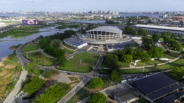 Aerial view of the Wole Soyinka Centre for Culture and Creative Arts and National Theatre Nigeria with its distinctive curved roof and green lawns in Lagos Lagos Nigeria. Aerial view of the Wole Soyinka Centre for Culture and Creative Arts and National Theatre Nigeria with its distinctive curved roof and green lawns in Lagos Lagos Nigeria.