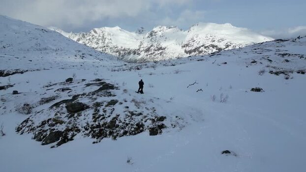 Aerial view of a person on a snowy hill in Kvaloya Norway.