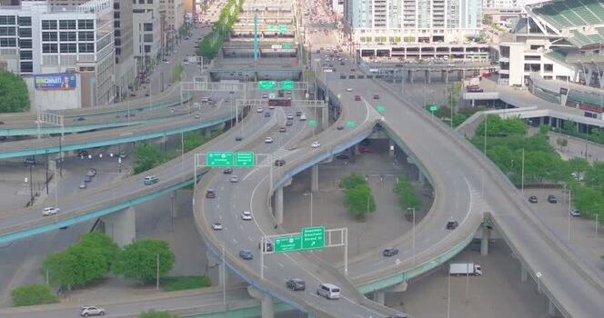 Aerial view of highway interchange and urban skyline United States. Aerial view of highway interchange and urban skyline United States.