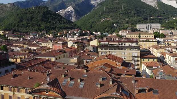 Aerial view of Carrara rooftops and Apuan Alps Italy. Aerial view of Carrara rooftops and Apuan Alps Italy.