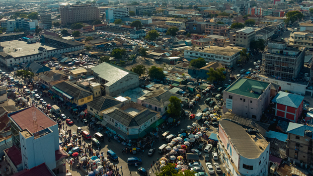 Accra Ghana 26 May 2023 Aerial view of the bustling urban landscape of Accra featuring dense market streets colorful umbrellas and various commercial buildings. Accra Ghana 26 May 2023 Aerial view of the bustling urban landscape of Accra featuring dense market streets colorful umbrellas and various commercial buildings.