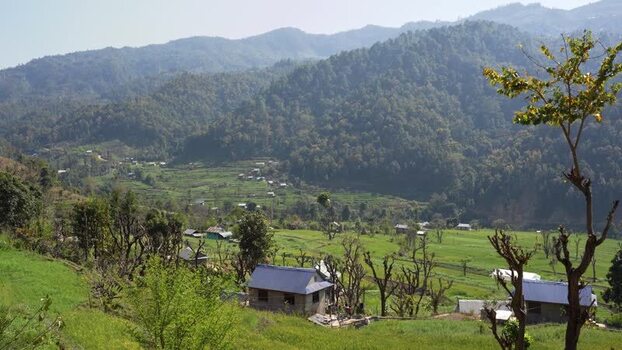 View of a rural village and terraced fields in a valley Nepal.