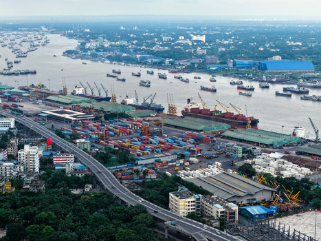 Aerial view of Chattogram Port with cargo ships shipping containers and industrial cranes in Chittagong Chittagong Division Bangladesh.