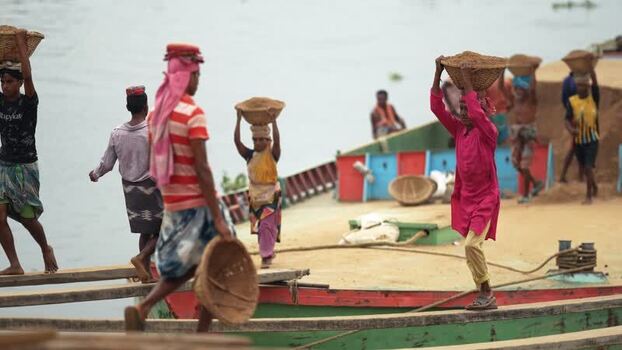 View of workers carrying sand baskets at Aminbazar Bangladesh. View of workers carrying sand baskets at Aminbazar Bangladesh.