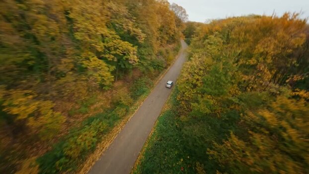 FPV aerial view of car on road in Fruska Gora Serbia. FPV aerial view of car on road in Fruska Gora Serbia.