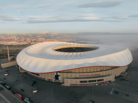 Aerial view of Riyadh Air Metropolitano Stadium with its distinctive curved roof and surrounding urban landscape in Madrid Comunidad de Madrid Spain.