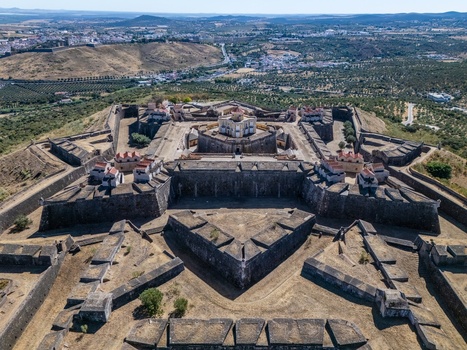 Elvas Portugal 10 September 2026 Aerial view of Forte de Nossa Senhora da Graca a star shaped fortress with stone walls and bastions surrounded by dry landscape and olive groves. Elvas Portugal 10 September 2026 Aerial view of Forte de Nossa Senhora da Graca a star shaped fortress with stone walls and bastions surrounded by dry landscape and olive groves.
