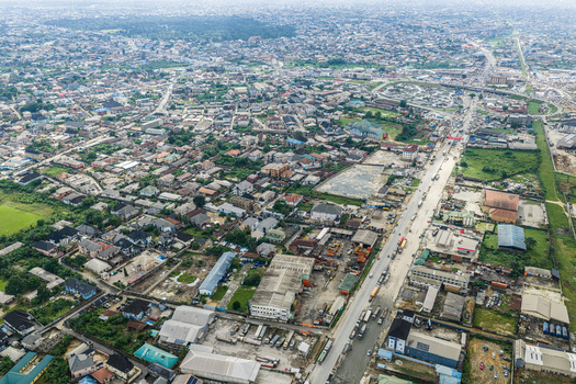 Port Harcourt Rivers Nigeria 03 July 2026 Aerial view of the urban landscape of Port Harcourt featuring dense residential housing industrial warehouses and a busy road network under a cloudy sky. Port Harcourt Rivers Nigeria 03 July 2026 Aerial view of the urban landscape of Port Harcourt featuring dense residential housing industrial warehouses and a busy road network under a cloudy sky.
