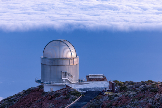View of Gran Telescopio Canarias dome situated on a rocky mountain peak above a dense layer of white clouds Canarias Spain. View of Gran Telescopio Canarias dome situated on a rocky mountain peak above a dense layer of white clouds Canarias Spain.