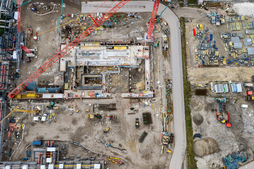 Aerial view of the construction site at the Heizkraftwerk Reuter West power plant featuring large cranes building foundations and industrial equipment in Berlin Berlin Germany.