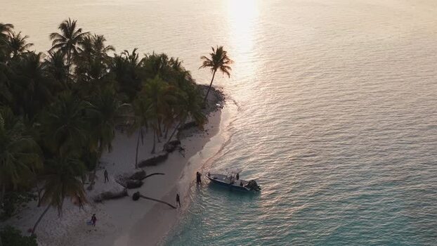 Aerial view of a boat near a tropical beach at sunset Maldives. Aerial view of a boat near a tropical beach at sunset Maldives.