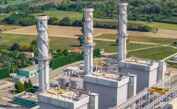 Aerial view of the three distinctive exhaust stacks and power generation units at the Chivasso combined cycle power plant in Chivasso Piedmont Italy.