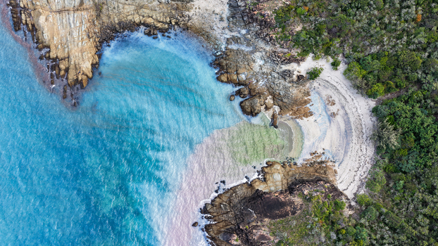 Aerial view of Chance Bay with turquoise waters sandy beach and rocky coastline in Whitsundays Queensland Australia. Aerial view of Chance Bay with turquoise waters sandy beach and rocky coastline in Whitsundays Queensland Australia.