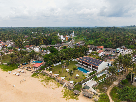 Aerial view of Kumarakanda Kumara Maha Viharaya temple with its golden Buddha statue and surrounding tropical greenery in Hikkaduwa Southern Province Sri Lanka. Aerial view of Kumarakanda Kumara Maha Viharaya temple with its golden Buddha statue and surrounding tropical greenery in Hikkaduwa Southern Province Sri Lanka.
