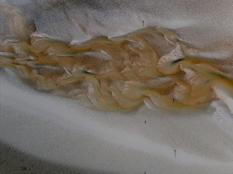 Aerial view of abstract tidal patterns at Culbin Sands with intricate water channels carved into the sand Nairn Scotland United Kingdom. Aerial view of abstract tidal patterns at Culbin Sands with intricate water channels carved into the sand Nairn Scotland United Kingdom.