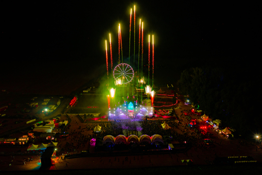Herzogenaurach Germany 22 July 2022 Aerial view of Open Beatz Festival with fireworks exploding over the main stage Ferris wheel and large crowds at night. Herzogenaurach Germany 22 July 2022 Aerial view of Open Beatz Festival with fireworks exploding over the main stage Ferris wheel and large crowds at night.