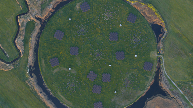 Aerial view of the LOFAR superterp radio telescope station with its circular green mound and geometric antenna arrays surrounded by water channels in Buinen Drenthe Netherlands. Aerial view of the LOFAR superterp radio telescope station with its circular green mound and geometric antenna arrays surrounded by water channels in Buinen Drenthe Netherlands.