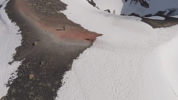Aerial view of people walking on a snowy ridge near Rifugio Sapienza Italy. Aerial view of people walking on a snowy ridge near Rifugio Sapienza Italy.