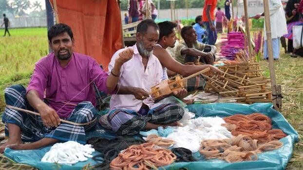 View of men preparing traditional kite string in Bogura Bangladesh. View of men preparing traditional kite string in Bogura Bangladesh.