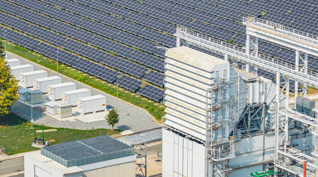 Aerial view of industrial power generation equipment with photovoltaic solar panels and battery energy storage systems at the Chivasso energy complex in Chivasso Piedmont Italy.