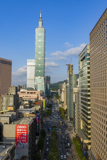Aerial view of the iconic Taipei 101 skyscraper rising above the dense urban skyline and busy streets of Taipei Taiwan. Aerial view of the iconic Taipei 101 skyscraper rising above the dense urban skyline and busy streets of Taipei Taiwan.