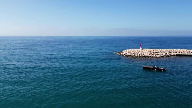 Aerial view of a motorboat near the Moraira breakwater Spain.