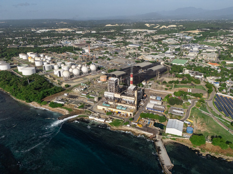 Aerial view of industrial city of Bajos de Haina featuring oil storage tanks power plant facilities and coastal infrastructure in Bajos de Haina San Cristobal Dominican Republic.