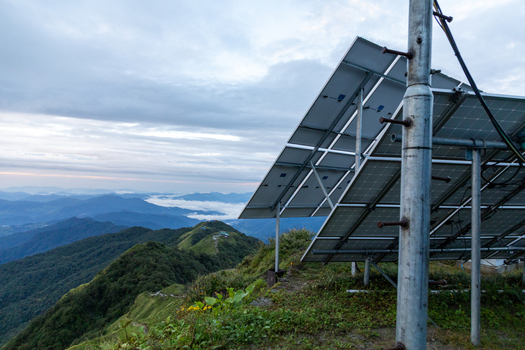 Pokhara Gandaki Province Nepal 27 August 2026 View of solar panels on a mountain ridge along the Mardi Himal Trek with green slopes and distant peaks under a cloudy sky.