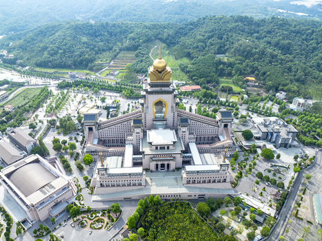 Aerial view of the Chung Tai Chan Monastery with its distinctive golden dome surrounded by lush green hills and landscaped gardens in Puli Township Nantou County Taiwan. Aerial view of the Chung Tai Chan Monastery with its distinctive golden dome surrounded by lush green hills and landscaped gardens in Puli Township Nantou County Taiwan.