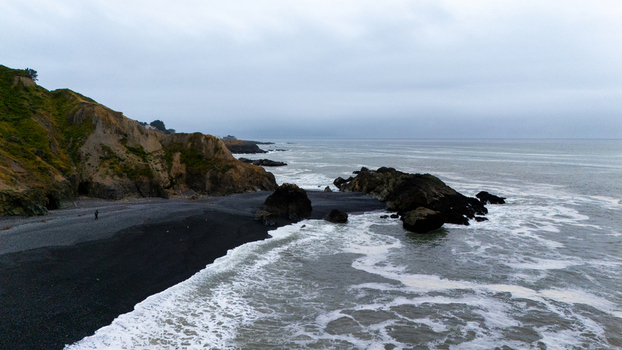 Aerial view of the rugged Lost Coast featuring black sand beaches steep cliffs and rocky outcrops along the Pacific Ocean in Humboldt County California United States.