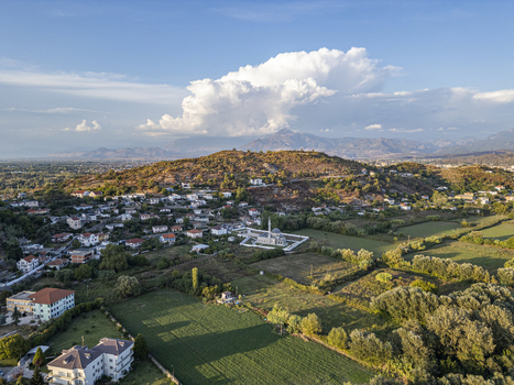 Aerial view of the Lead Mosque surrounded by rural landscape houses and green fields in Shkoder Shkoder County Albania. Aerial view of the Lead Mosque surrounded by rural landscape houses and green fields in Shkoder Shkoder County Albania.
