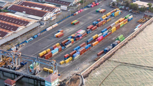 Semarang Central Java Indonesia 27 September 2026 Aerial view of a busy container terminal with colorful shipping containers industrial cranes and warehouses along the coast. Semarang Central Java Indonesia 27 September 2026 Aerial view of a busy container terminal with colorful shipping containers industrial cranes and warehouses along the coast.