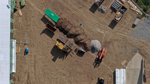 Aerial view of a construction site featuring heavy machinery piles of earth and building materials in Boulder Colorado United States. Aerial view of a construction site featuring heavy machinery piles of earth and building materials in Boulder Colorado United States.