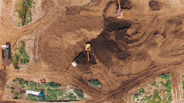 Aerial view of construction site with excavators and trucks moving earth in Chennai India. Aerial view of construction site with excavators and trucks moving earth in Chennai India.