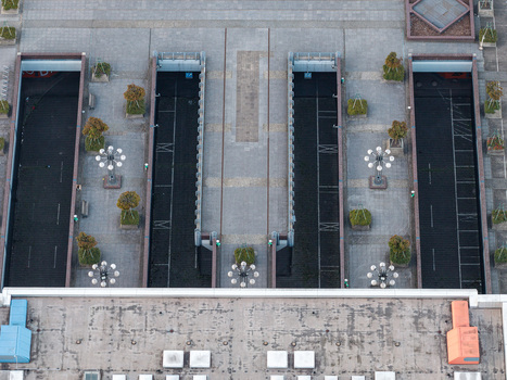 Aerial view of the brutalist architecture of the ICC Berlin featuring geometric concrete structures paved plazas and symmetrical lighting fixtures in Berlin Berlin Germany. Aerial view of the brutalist architecture of the ICC Berlin featuring geometric concrete structures paved plazas and symmetrical lighting fixtures in Berlin Berlin Germany.