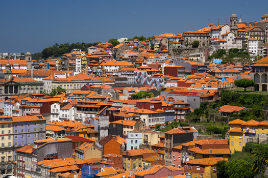 Aerial view of terracotta rooftops cascade down the hillside towards the Douro River a vibrant tapestry of color and history Porto Porto District Portugal. Aerial view of terracotta rooftops cascade down the hillside towards the Douro River a vibrant tapestry of color and history Porto Porto District Portugal.