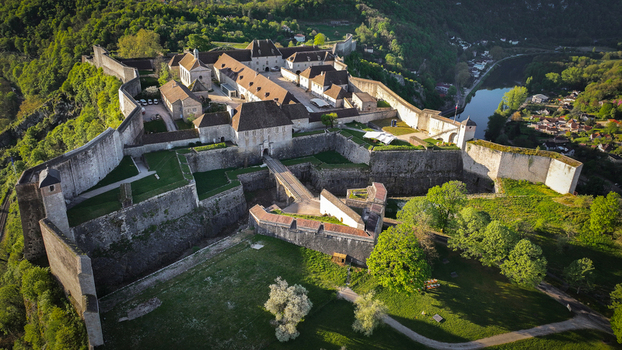 Aerial view of the Besancon Citadel featuring its massive stone fortifications and historic buildings overlooking the Doubs river valley in Besancon Bourgogne Franche Comte France. Aerial view of the Besancon Citadel featuring its massive stone fortifications and historic buildings overlooking the Doubs river valley in Besancon Bourgogne Franche Comte France.